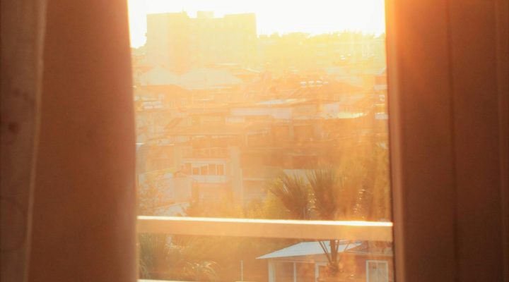 Enjoy the serenity of morning sunlight streaming through a window with a warm cup of coffee.